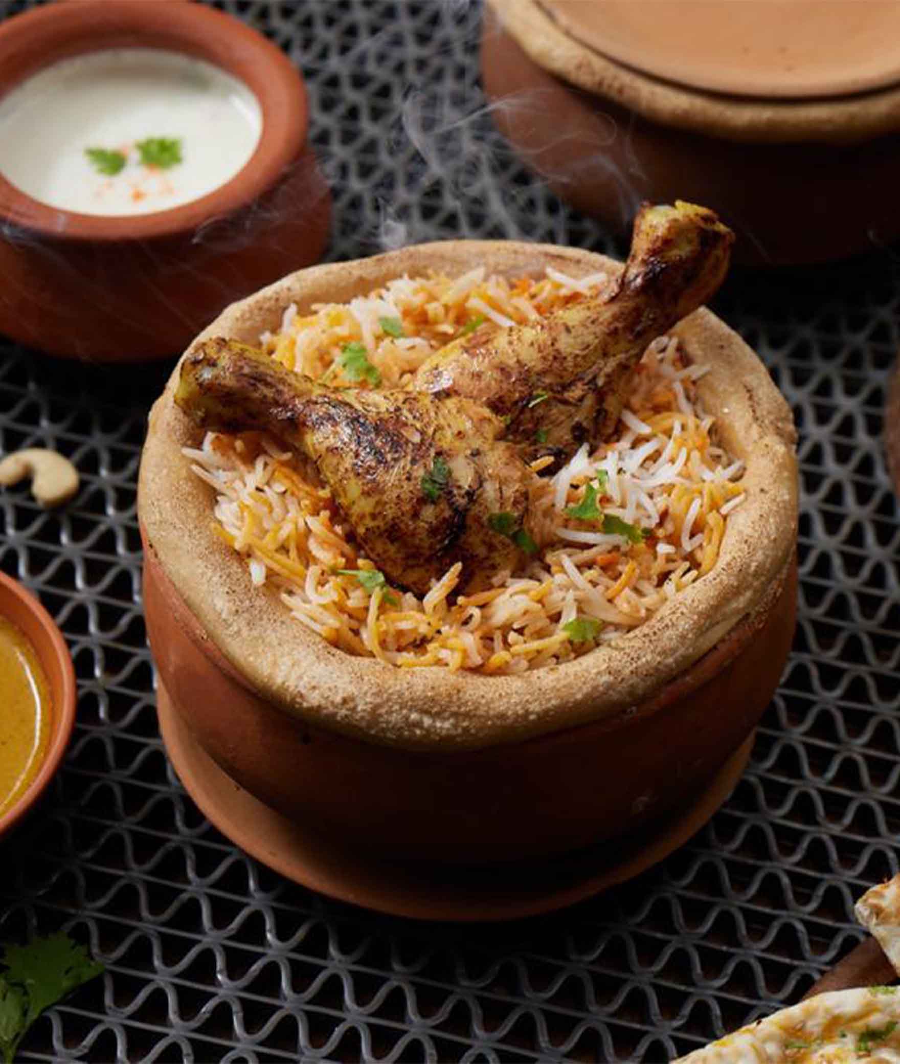 Dum Pukht Biryani by Aromas - Logo