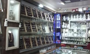 Puran Jewellers And Bankers - Logo