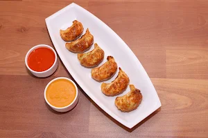 Suraj Lama Momos - Logo
