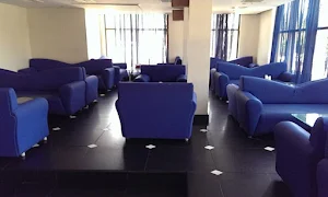 Unwind - Hotel NKM's Grand - Logo